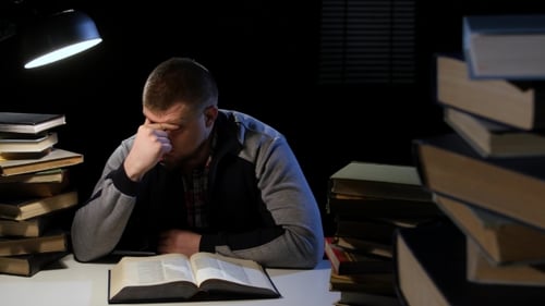 Man Leafing Through the Book, He Is Sleepy and Tired. Black Background
