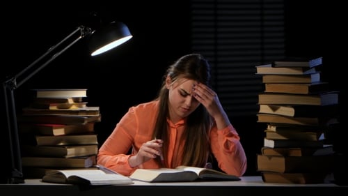Girl Thumbs Through the Book and It Hurts Headaches. Black Background