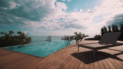 Wicker Recliner Near Small Outside Swimming Pool on Hill Over Ocean