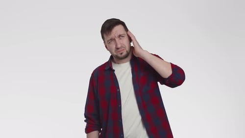 Caucasian Man Grabs Ear From Tinnitus on White Background in the Studio Front View