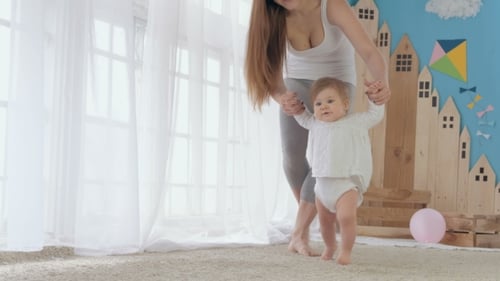 Mother Helping Baby To Walk