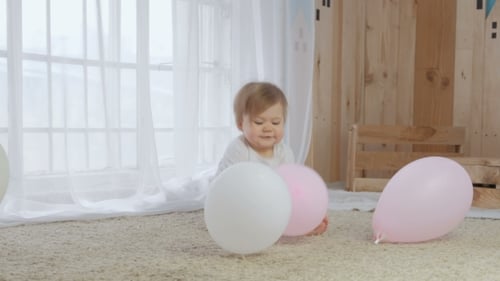 Sweet Baby Playing with Balloons at Home