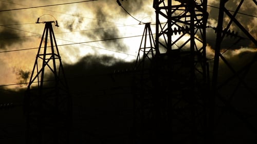 High Voltage Electrical Tower at Sunset a Cloudy Day