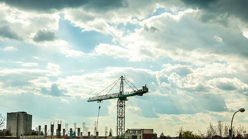 Construction Crane Lifting Building Materials in Timelapse