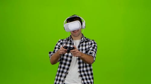 Man Plays on Gamepad with Headphones and Vr Glasses. Studio