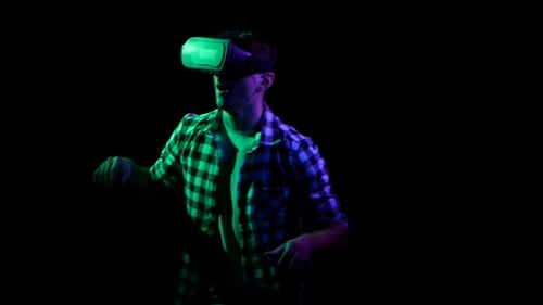 Man Playing Online Games in Virtual Reality Glasses. Black Studio