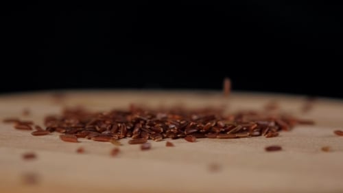 Red Rice Grains Being Poured Close Up