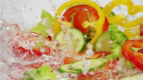 Slices of Ripe Vegetables are Falling on the Table