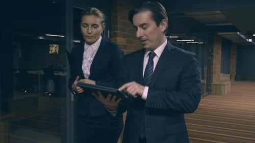 Business People Discussing Tablet in Modern Office