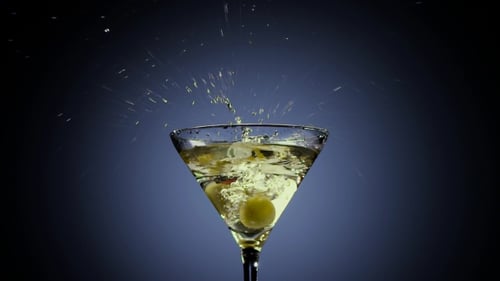 Olives Dropping into a Cocktail Glass