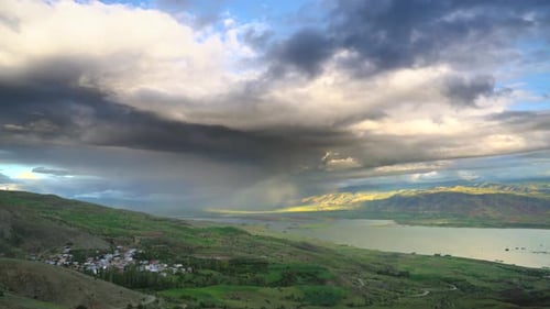 Rain Approaching to Lake Geography Surrounded by Hilly Meadows