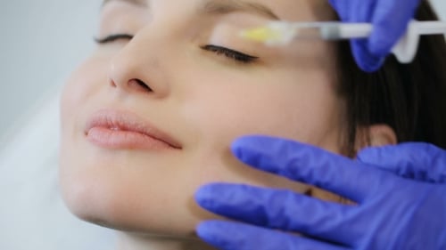 Woman Receive Botox Injection in Lips