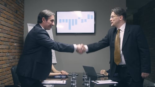 Business People Signing Contracts During Corporate Meeting