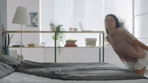 Woman Jumping on Bed and Sleeping