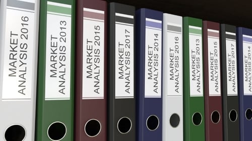 Line of Multicolor Office Binders with Market Analysis Tags Different Years