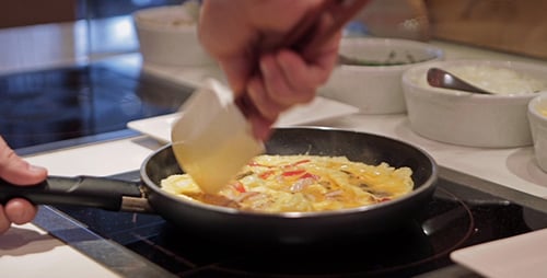 Person Cooking an Omelet at Home