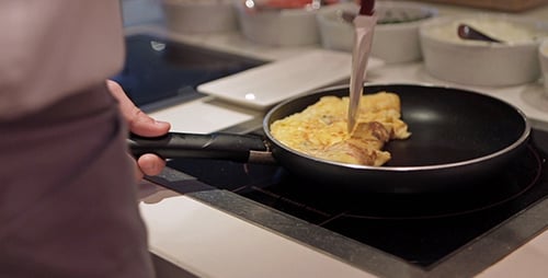 Chef Folds a Fresh Omelet in a Pan