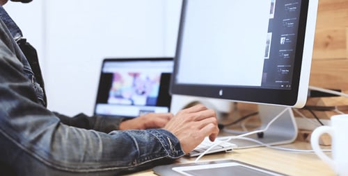 Creative Person Using Tablet and Computer in Office
