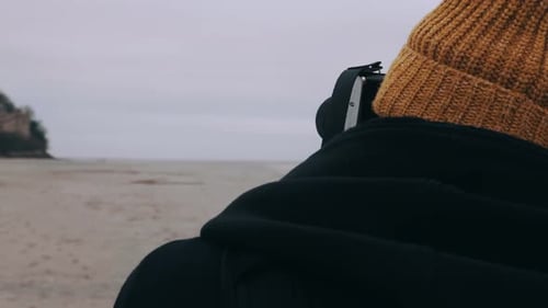 Rear View Photographer Man Taking Picture of Epic Mont Saint Michel Island Castle on Overcast Day
