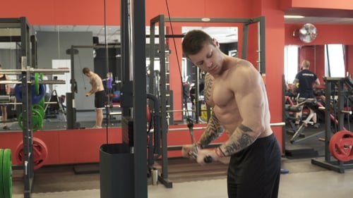 Man Doing Tricep Pushdowns in Fitness Center
