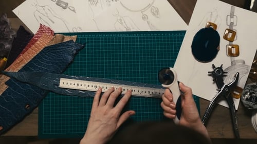 Hands Crafting Leather Jewelry with Tools