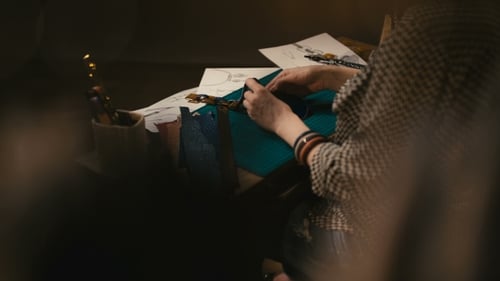 Crafter Working on Leather at a Dark Desk