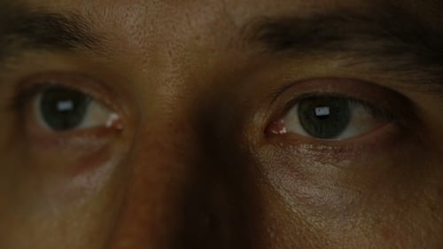 Eye of a Man Reflecting Pictures and Internet Pages.