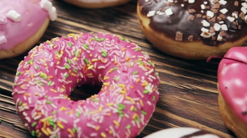 Assortment of Delicious Donuts on Wooden Surface