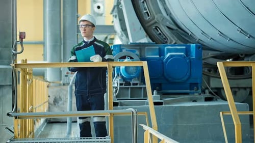Engineer Signing a Document in Industrial Factory