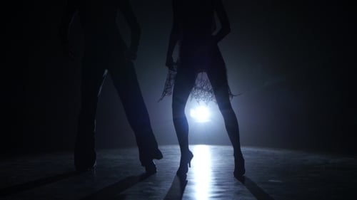 Dance Couple Demonstrating Magnificent Choreography of Latino, Black Background. Close-ups