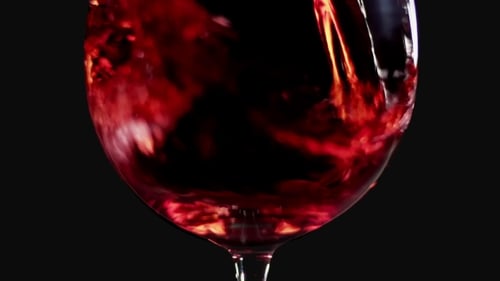 Filling Wine Glass with Red Wine Super Shot, Black Background