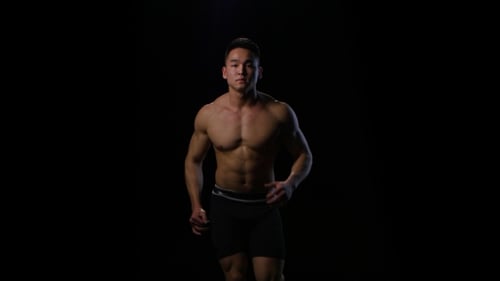 Athlete Run on the Black Background at Fast Pace. Studio