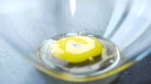 Egg Yolk Dropped Into Bowl of Egg White