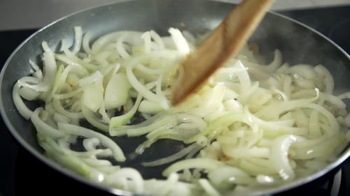 Chef Fryes Onion in a Hot Frying Pan, Vegetables Are Cooked, Meals with Vegetables