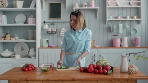Woman Prepares Vegetables and Dances in Bright Kitchen
