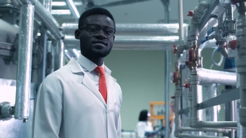 Confident Scientist in Lab with Industrial Piping