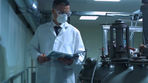 Scientist Writing in Journal While Standing in Lab