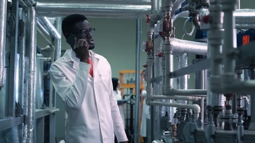 Scientist Talking Phone on Factory