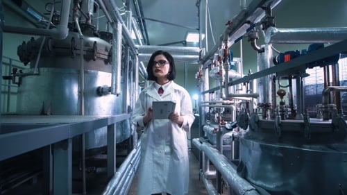 Woman with the Tablet on Chemistry Factory