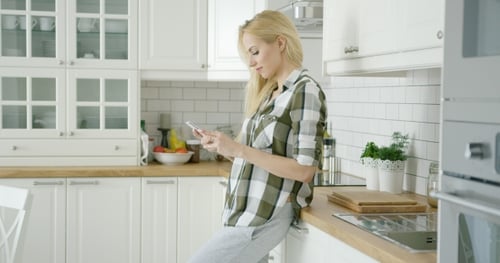 Young Woman Using Phone at Home