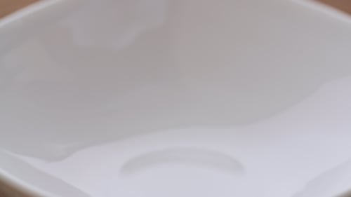 Cereal Being Poured Into White Bowl Close Up