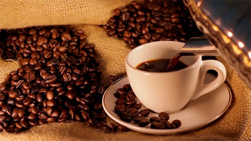Coffee Being Poured into a White Cup