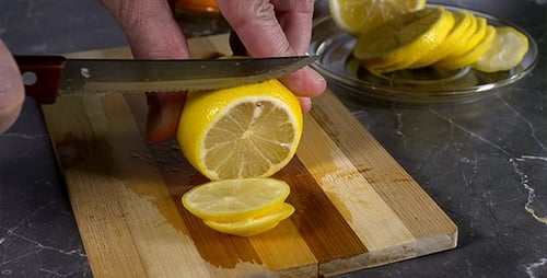 Slicing a Lemon on a Cutting Board