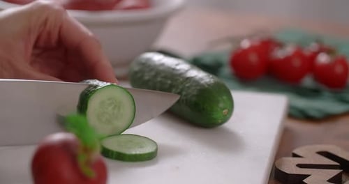 Housewife Cooks Vegetable Salad and Slices Cucumber on the Cut Board 60p Prores HQ