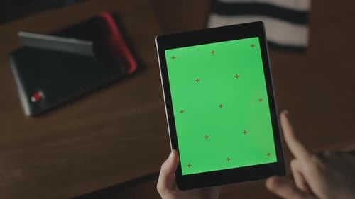 Female Hand Holding Tablet. Close Up Woman Swiping Tablet Green Screen