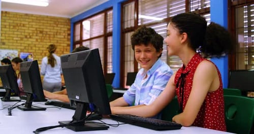 Teens Work Together at School Computer Workstation