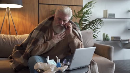 Adult Man on Phone with Cold on Couch