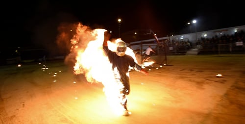 Flame Performer Juggling Torches at Night
