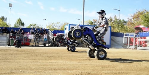 Skilled ATV Riders Performing Stunts for Crowd