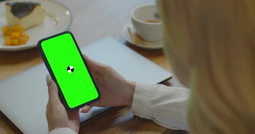 Business Woman Using Smartphone Viewing Green Screen on Mobile Phone Browsing Chroma Key Online